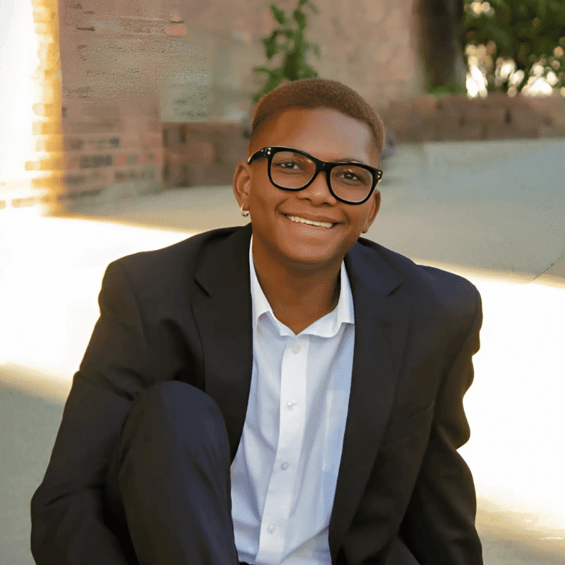 Portrait of Javon Hunter, a professional stylist at Noir et Blanc Salon, showcasing their expertise and style.